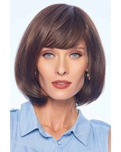 Woman in a past the chin medium brown rounded bob wig with blunt bangs