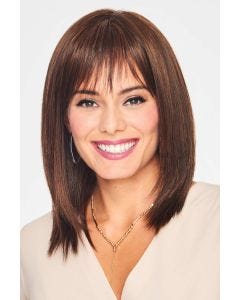 Woman in a past the shoulders straight medium brown wig with bangs