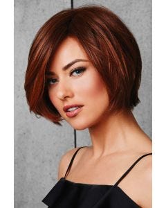 Woman in a chin length medium auburn rounded bob wig