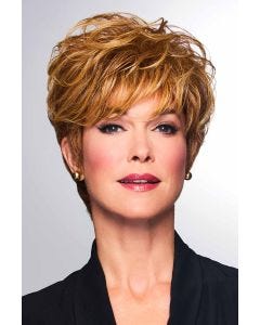 Woman in a medium brown pixie wig with side bangs and longer hair on the top