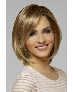 Woman in a blonde shoulder length layered bob wig