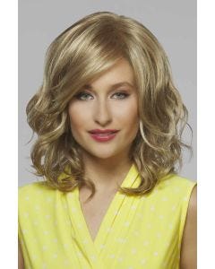 Woman in a chin length warm blonde curly wig with side bangs