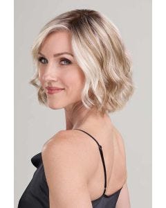 Woman in a chin length platinum blonde wavy wig