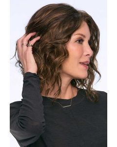 Woman in a shoulder length dark auburn curly lace front wig