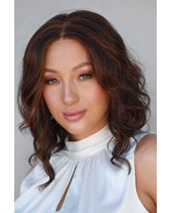 Woman in a petite past the shoulders dark auburn curly lace front wig