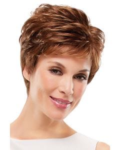 Woman in an auburn pixie wig with feathered layers and short fringe bangs