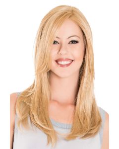 Woman in an 18" warm light blonde hair topper with long bangs blended with her hair