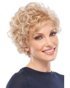 Woman in petite short curly blonde wig with bangs and layers for an older woman