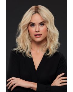 Woman in a shoulder length golden blonde curly remy human hair wig with dark roots