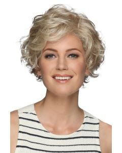 Woman in a long curly dark blonde layered pixie wig