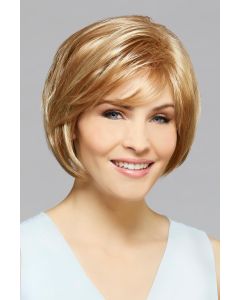 Woman in a chin length ginger blonde bob wig with longer layers along the face and side swept bangs