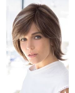 Woman in a shoulder length medium brown bob wig with side bangs and long layers