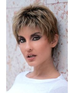 Woman in a short light red textured pixie wig with dark longer hair on top and dark roots