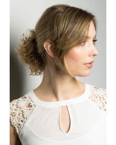 Woman in a light auburn curly hair scrunchie