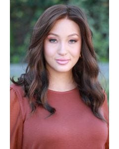 Woman in a past the shoulders dark brown curly lace front wig