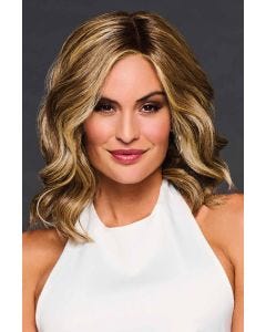 Woman in a shoulder length warm light brown wavy lace front wig