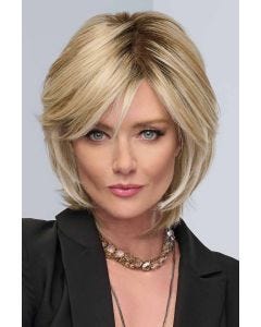 Woman ina shoulder length warm blonde layered bob wig with side bangs