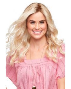Woman in a an extra long platinum blonde curly lace front wig