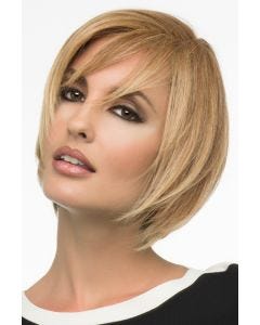Woman in a chin length warm blonde bob wig with wispy side bangs