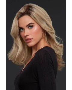 Woman in a long past the shoulders blonde wig with dark roots, barrel curls, and long layers