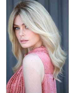 Woman in an extra long light blonde curly wig with long curtain bangs