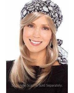 Woman in a long straight halo hair piece with long bangs under a black and white head scarf