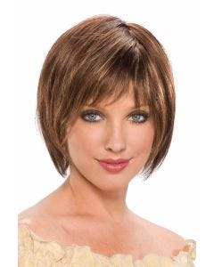Woman in a chin length medium brown rounded bob wig with fringe bangs