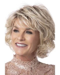 Woman in a chin length light blonde curly bob wig with side bangs