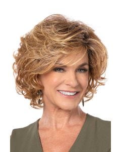 Woman in a past the chin light auburn curly layered bob wig