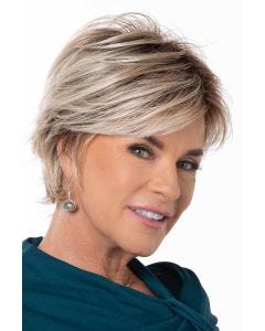 Woman in a light blonde long pixie wig with side bangs