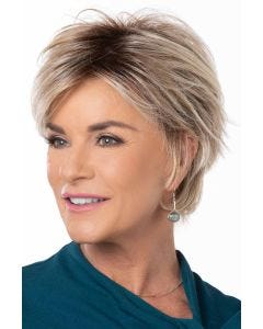 Woman in a large light blonde long pixie wig with side bangs