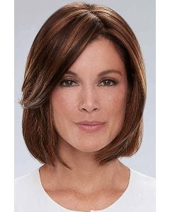 Woman in a shoulder length medium auburn wig with long side bangs