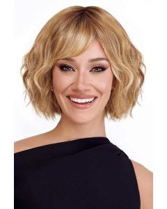 Woman in a chin length wavy ash blonde lace front wig with choppy bangs