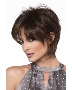 Woman in a short, dark brown long layered human hair wig with wispy bangs