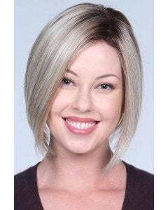 Woman in a chin length slightly angled light blonde bob wig
