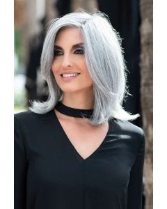 Woman in a past the shoulders straight light blonde light blonde wig with long face framing layers