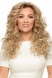 Woman in an extra long curly layered warm blonde wig