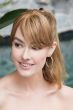 Woman in a 6" light auburn human hair topper with 4.5" bangs