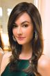 Woman in a long dark brown layered wig
