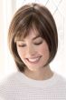 Woman in brown short chin length bob wig with layers and bangs
