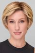 Woman in a blonde classic pixie style wig with feathered bangs and darker layers