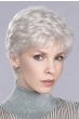 Woman in an evenly layered curly light blonde lace front pixie wig