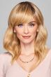 Long layered wavy wig with side-swept bangs and soft blonde highlights for natural everyday wear.