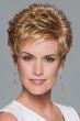 Woman in a strawberry blonde pixie wig with curled spiky layering on top and fringe bangs
