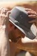 Man outdoors in brimmed cooling soaker hat with water falling down over the hat