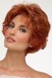 Woman in long light red textured pixie wig with longer layers at the top