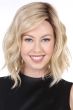 Woman in a shoulder length light blonde wavy lace front wig