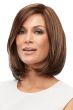 Woman in a large shoulder length blunt cut medium brown wig