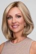 Woman in a shoulder length blonde blunt bob wig with long layers