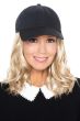 Woman in black baseball cap with blonde curly long hair attached